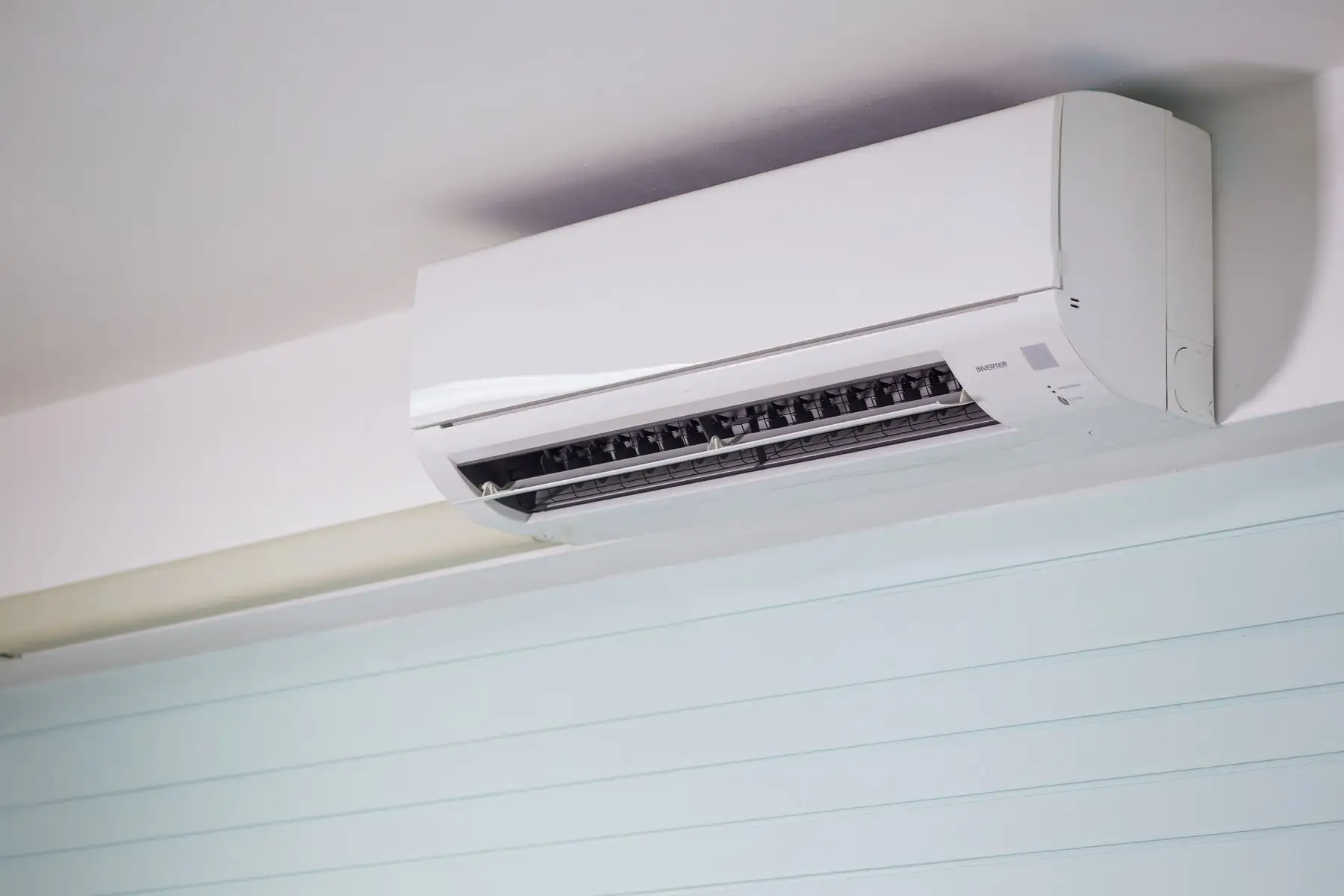 A wall-mounted split system head installed above a window in a Far North Queensland home
