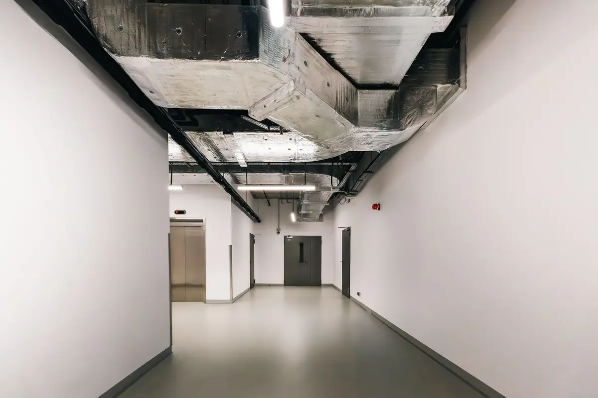 Exposed ductwork running through a ceiling space